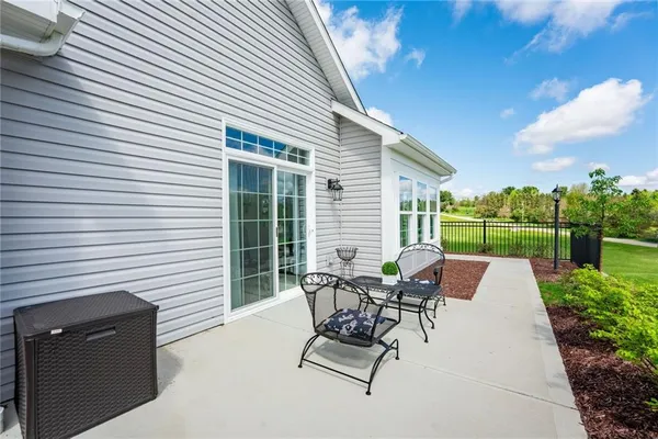 a view of a patio with a table and chairs