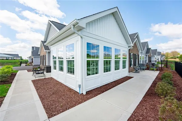 a view of a house with backyard and porch