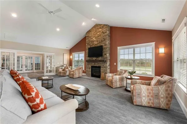 a living room with fireplace furniture and a fireplace