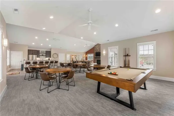 a room with furniture pool table and windows