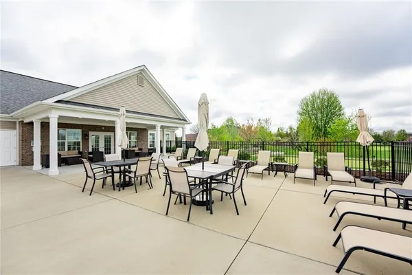 a view of a patio with table and chairs