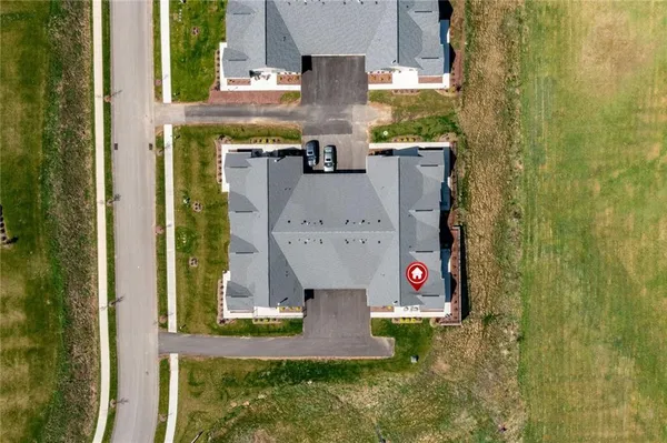 an aerial view of a house with a yard and fountain