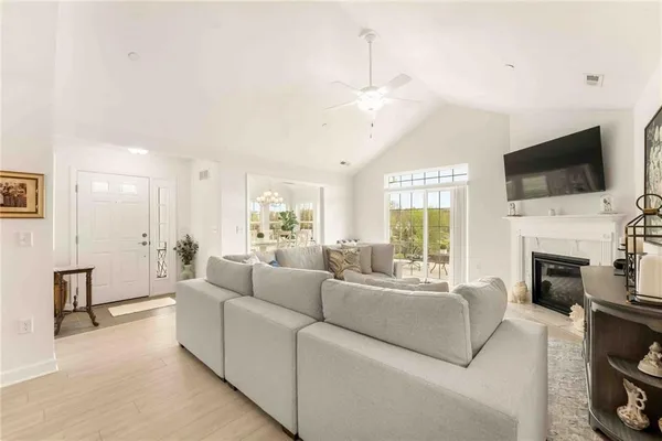 a living room with fireplace furniture and a flat screen tv