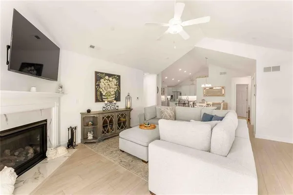 a living room with furniture a fireplace and a flat screen tv