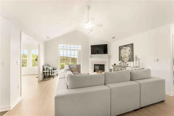 a living room with furniture a fireplace and a flat screen tv