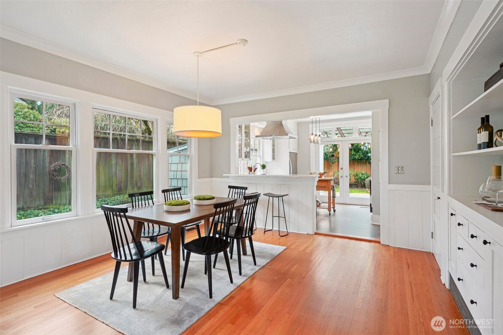 3141 Broadway East Seattle, WA 98102 - Photo 11 of 40 a dining room with furniture large windows and wooden floor