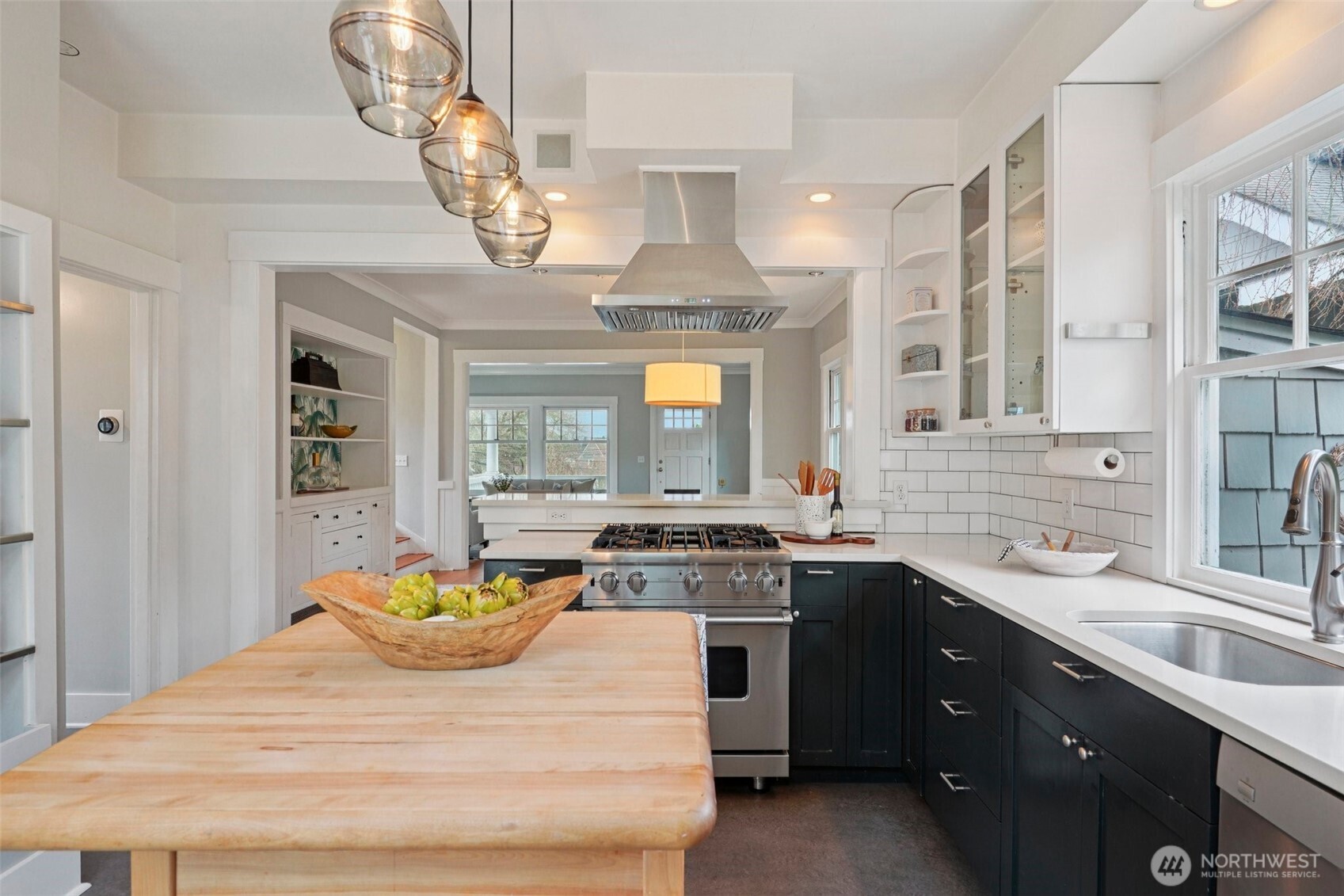 3141 Broadway East Seattle, WA 98102 - Photo 15 of 40 a kitchen with a stove a sink dishwasher a dining table and chairs