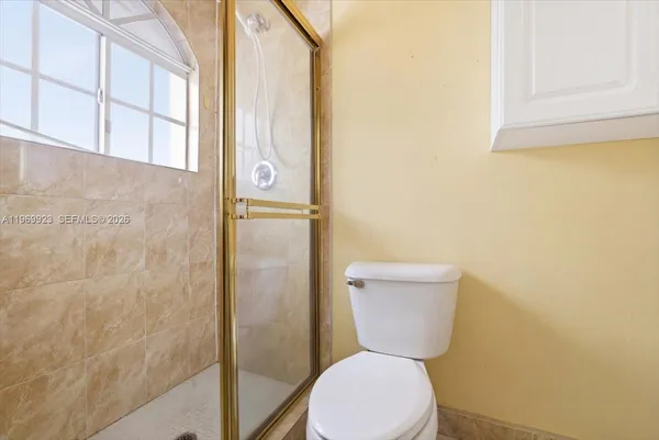 a white toilet sitting next to a bathroom sink