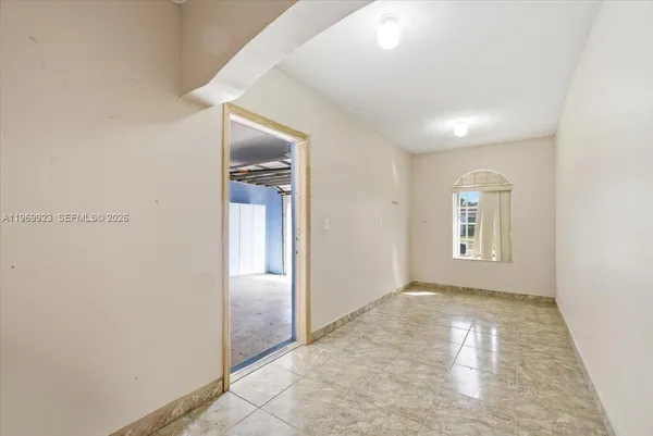 an empty room with windows and closet