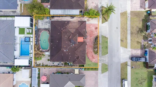 an aerial view of residential house with outdoor space and parking