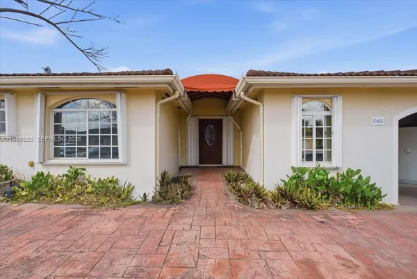 a view of a house with potted plants