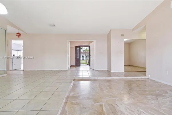a view of an empty room with glass door