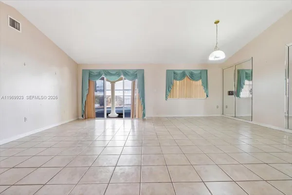 a view of an empty room with glass door