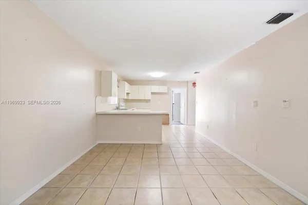 a view of kitchen with white cabinets