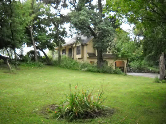20364 Free Church Road Caledonia, IL 61011 - Photo 2 of 6 a front view of a house with a garden