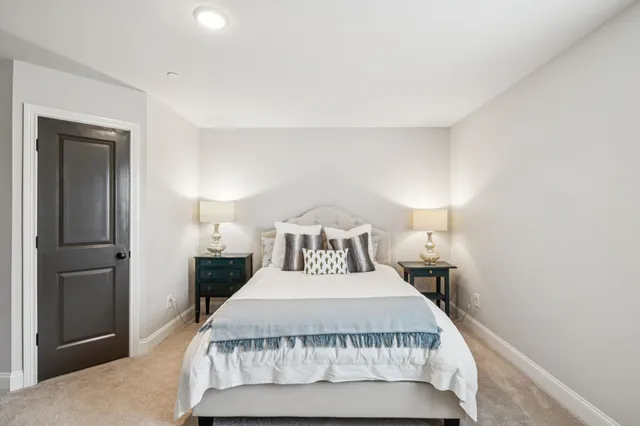 a bedroom with a bed and a night stand