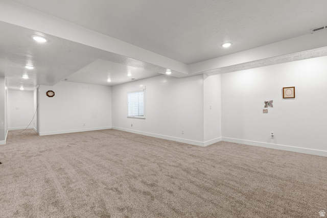 463 South Trejo Ridge Road Grantsville, UT 84029 - Photo 18 of 22 Spacious lower level featuring light-toned carpet, recessed lighting, and a window with horizontal blinds