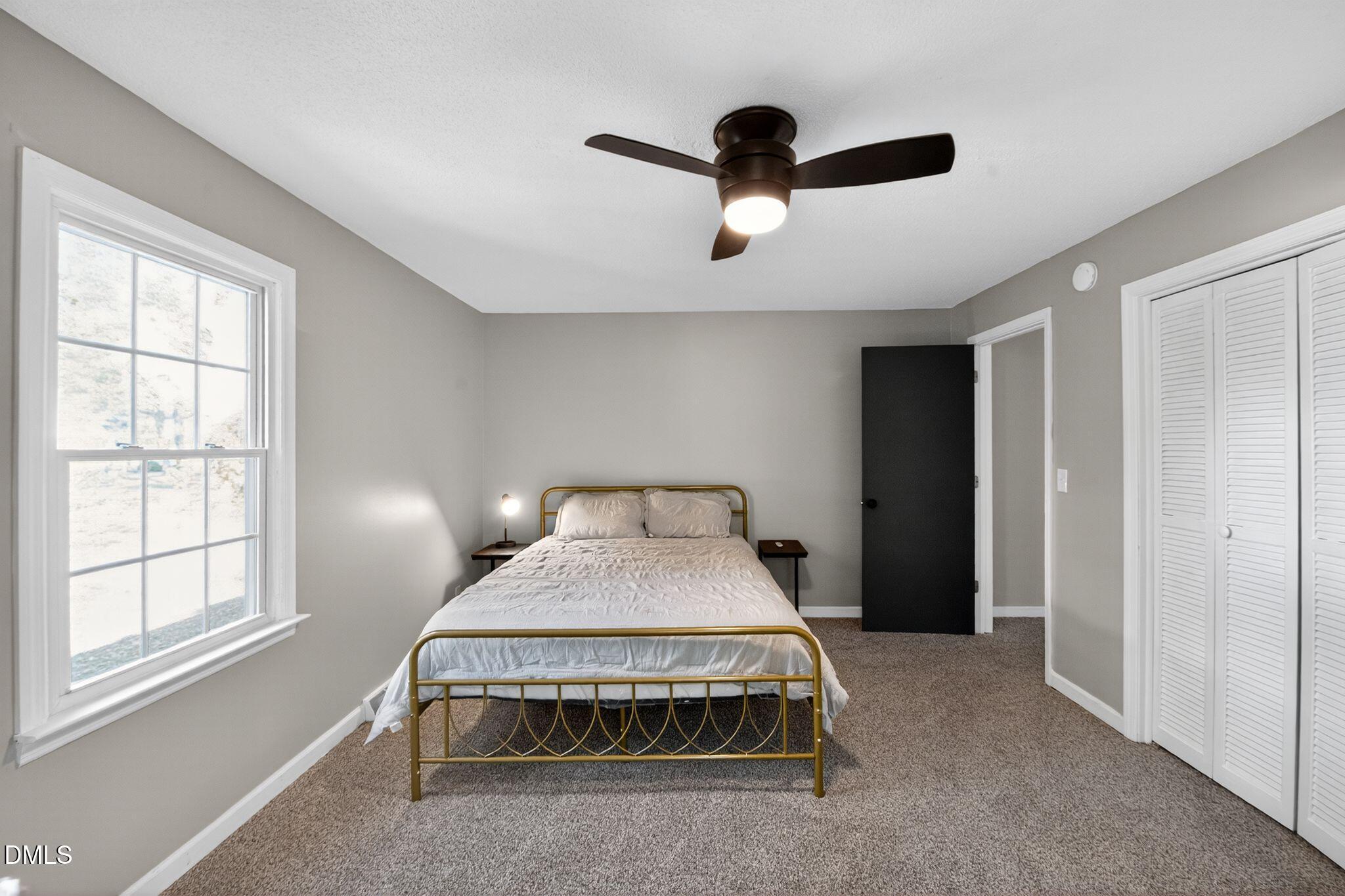 518 East 3rd Street Wendell, NC 27591 - Photo 15 of 30 a bed sitting in a room next to a window