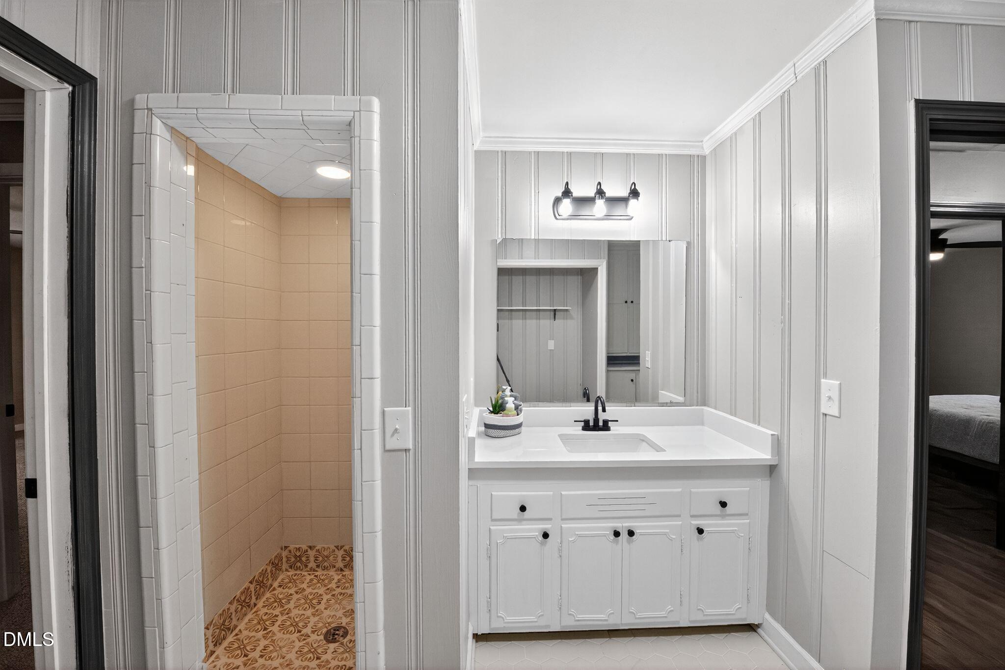 518 East 3rd Street Wendell, NC 27591 - Photo 16 of 30 a bathroom with a sink double vanity and a mirror