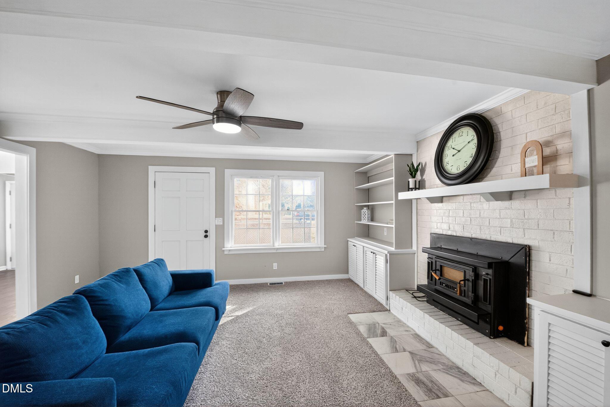 518 East 3rd Street Wendell, NC 27591 - Photo 18 of 30 a living room with furniture a fireplace and a large window