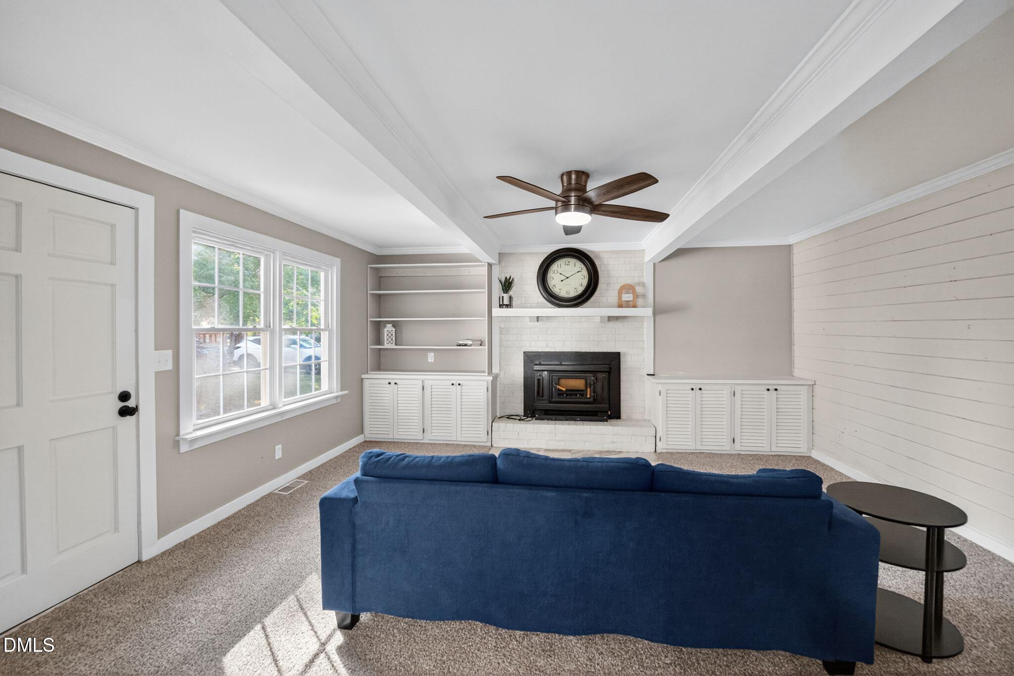 518 East 3rd Street Wendell, NC 27591 - Photo 19 of 30 a living room with furniture a fireplace and a window