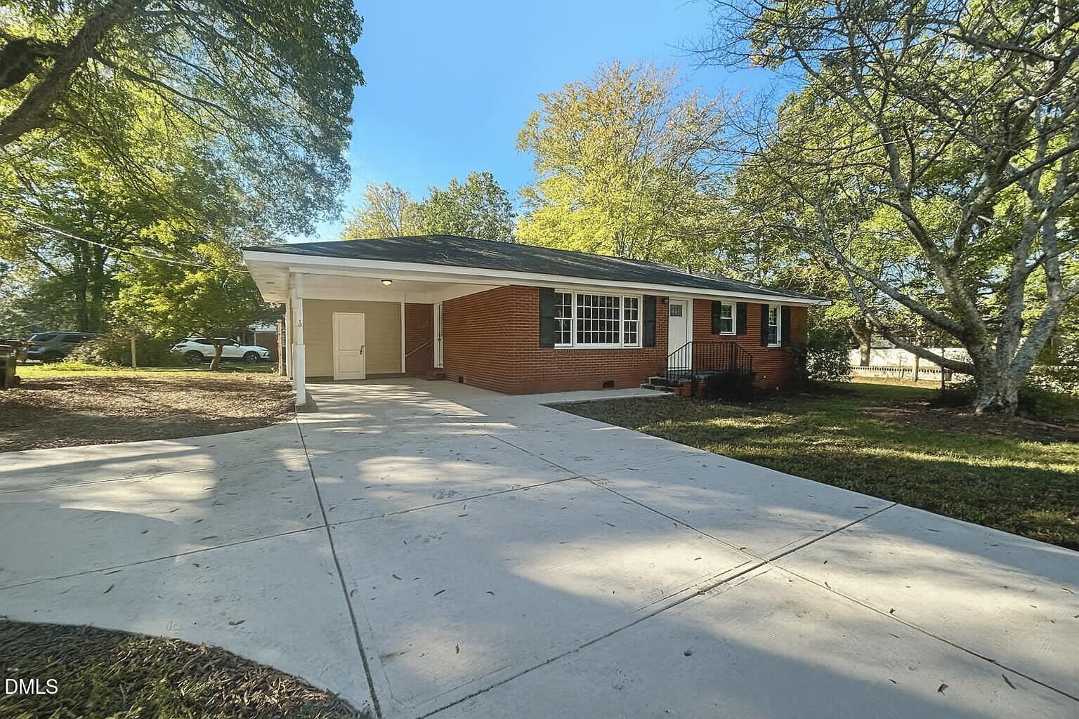 518 East 3rd Street Wendell, NC 27591 - Photo 2 of 30 a view of backyard with a garden and trees