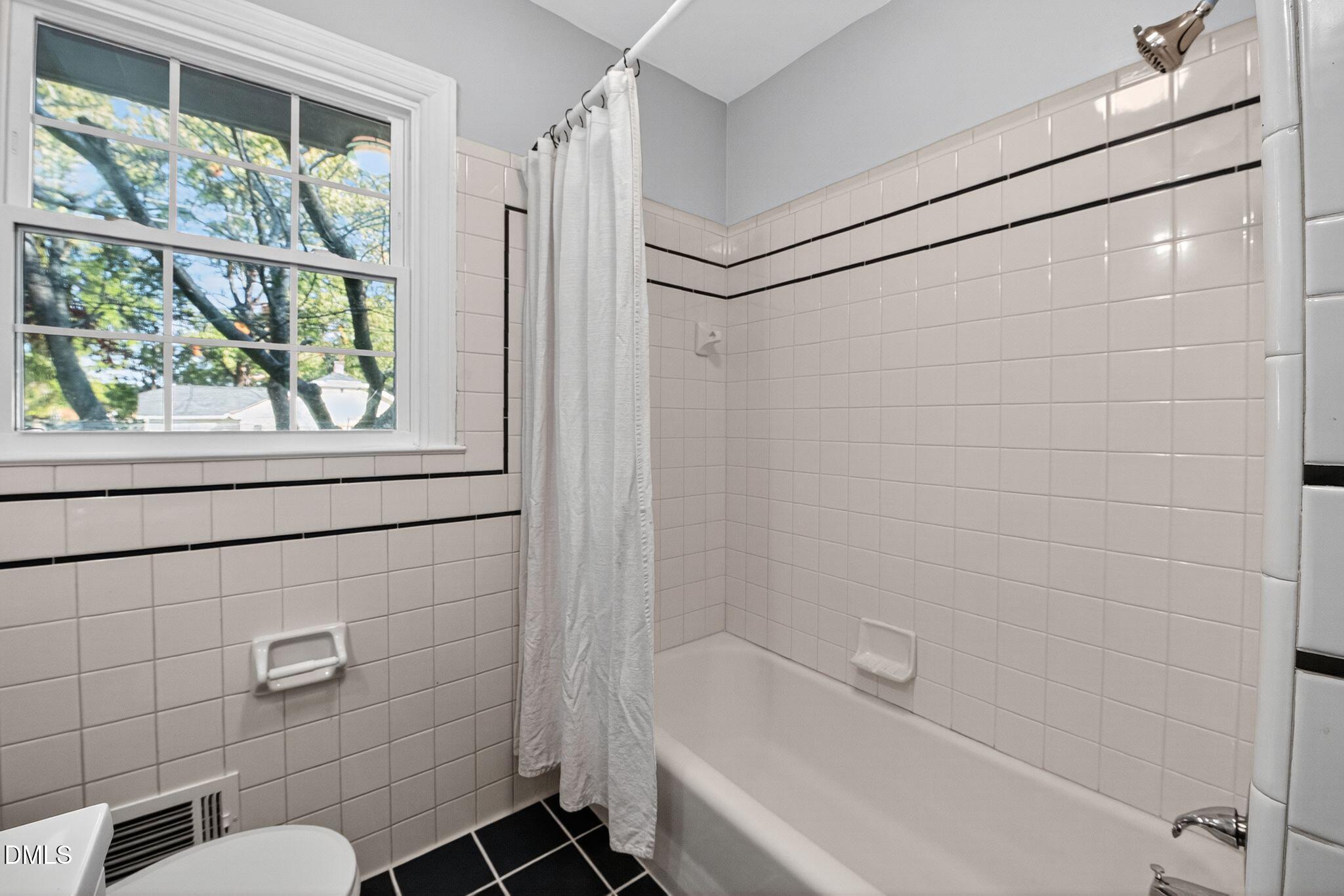 518 East 3rd Street Wendell, NC 27591 - Photo 21 of 30 a bathroom with a shower and a bathtub