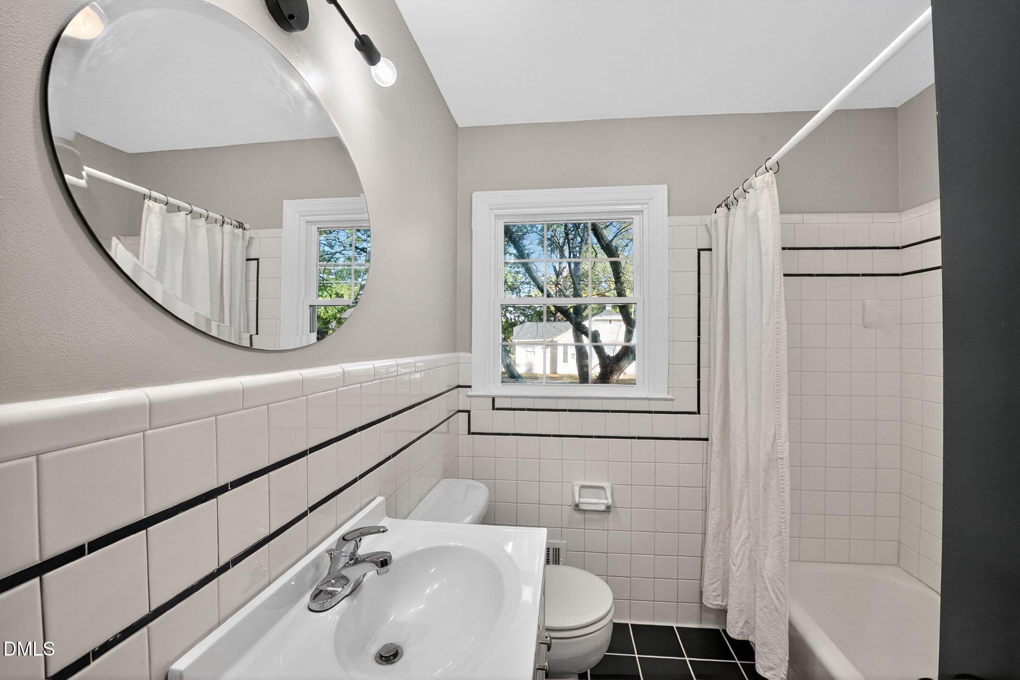 518 East 3rd Street Wendell, NC 27591 - Photo 22 of 30 a bathroom with a sink a toilet and a mirror