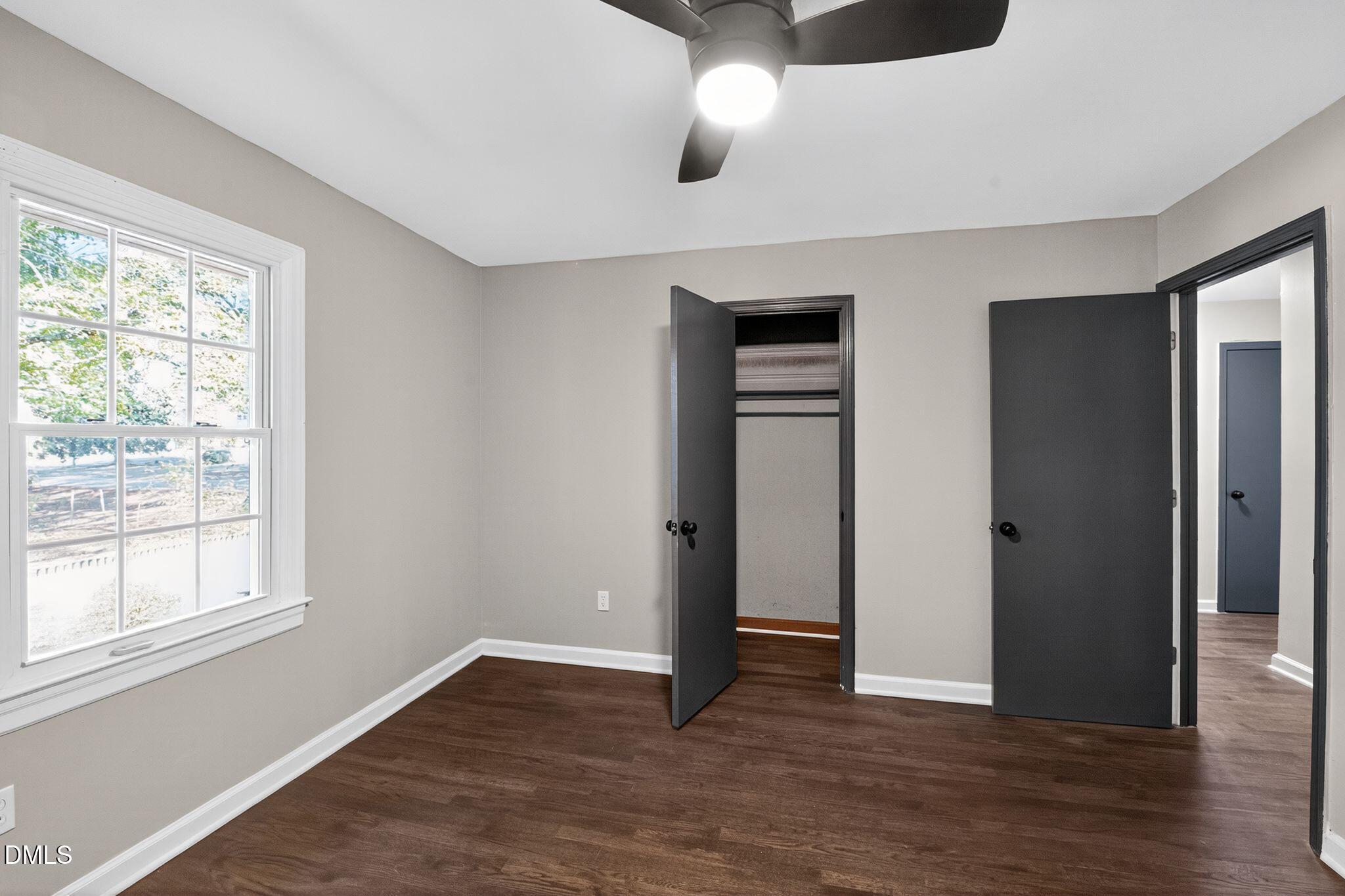 518 East 3rd Street Wendell, NC 27591 - Photo 23 of 30 an empty room with wooden floor and windows