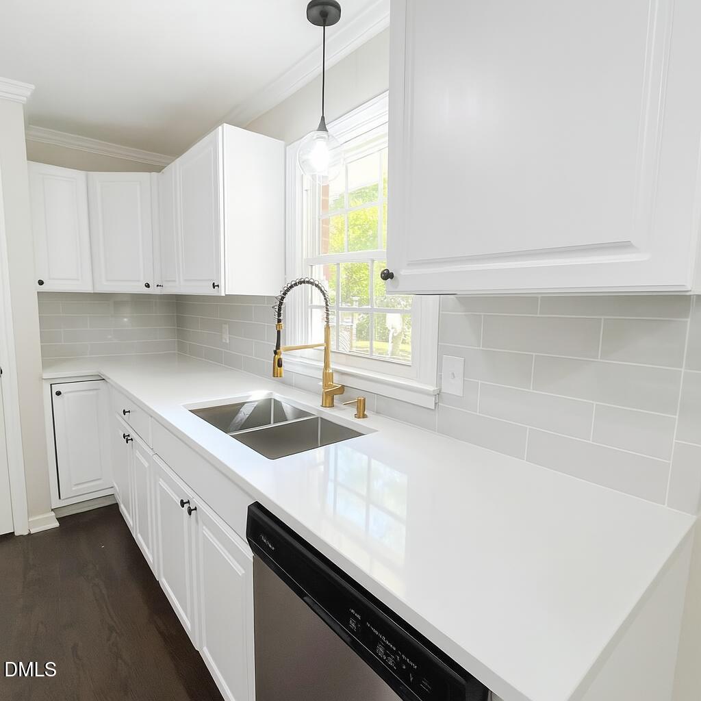 518 East 3rd Street Wendell, NC 27591 - Photo 3 of 30 a kitchen with a sink a stove cabinets and a window