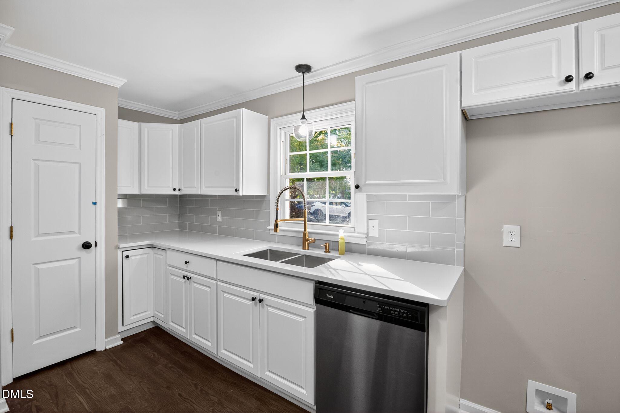 518 East 3rd Street Wendell, NC 27591 - Photo 6 of 30 a kitchen with a sink cabinets and window