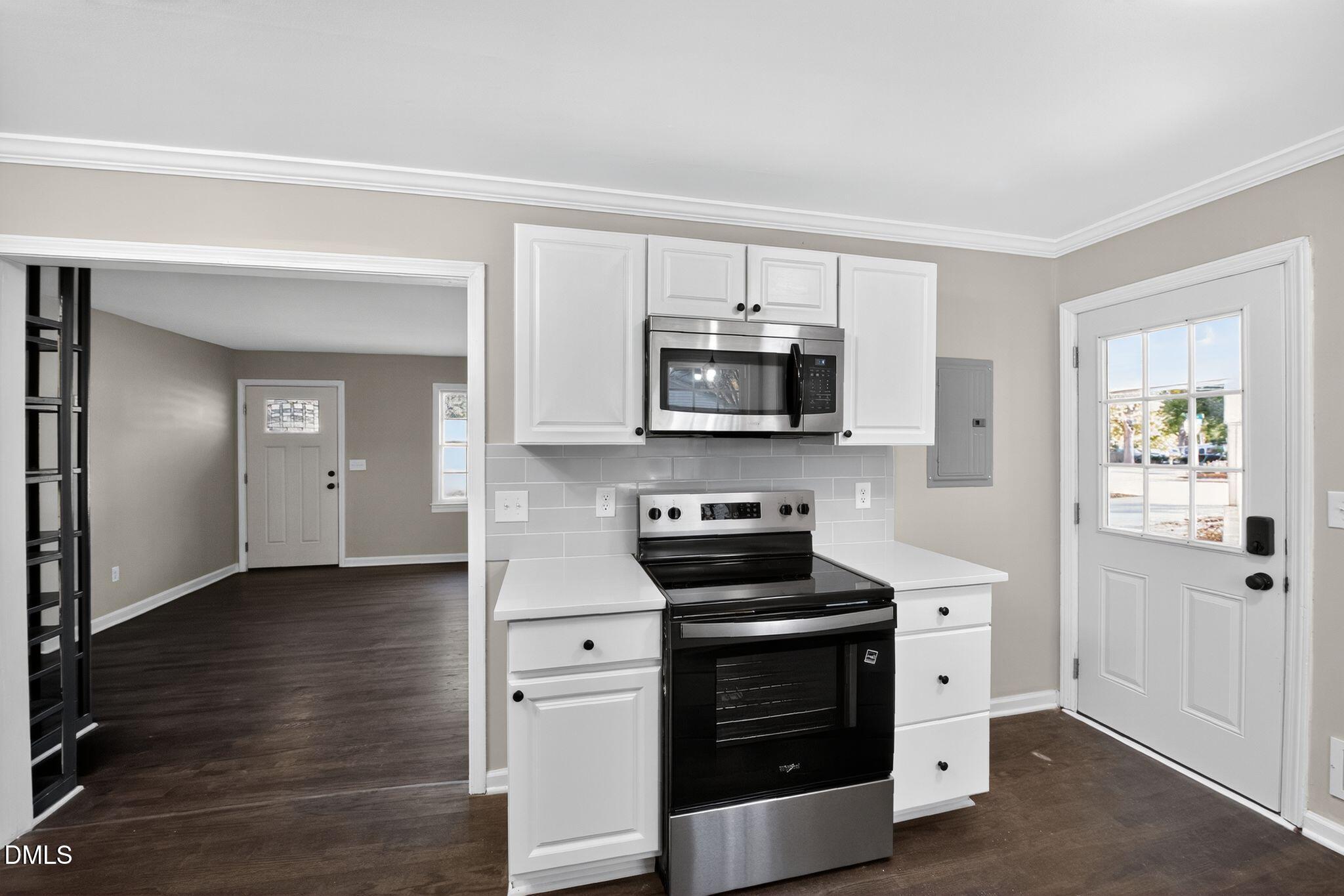 518 East 3rd Street Wendell, NC 27591 - Photo 7 of 30 a kitchen with stainless steel appliances a stove microwave and sink