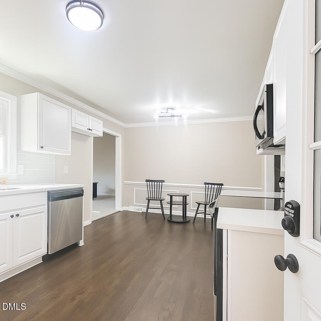 518 East 3rd Street Wendell, NC 27591 - Photo 8 of 30 a kitchen with table chairs sink and cabinets