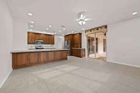 a view of kitchen with refrigerator and microwave