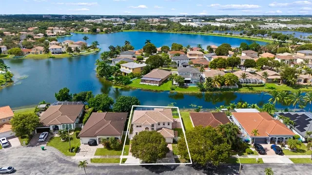an aerial view of residential houses with outdoor space and river