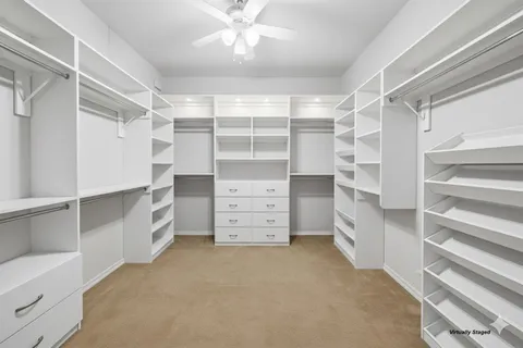 a view of walk in closet with empty racks