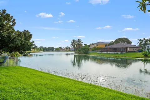 a view of a lake with houses in the back
