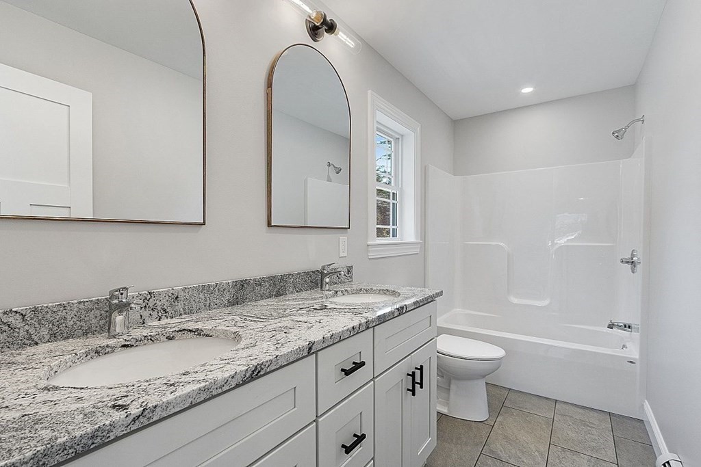 245 Brookside Road Orange, MA 01364 - Photo 12 of 29 a bathroom with a granite countertop sink a toilet and bathtub