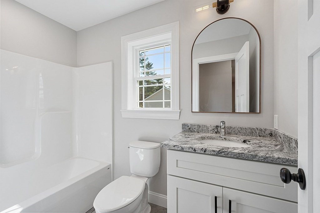 245 Brookside Road Orange, MA 01364 - Photo 17 of 29 a bathroom with a granite countertop toilet sink and mirror