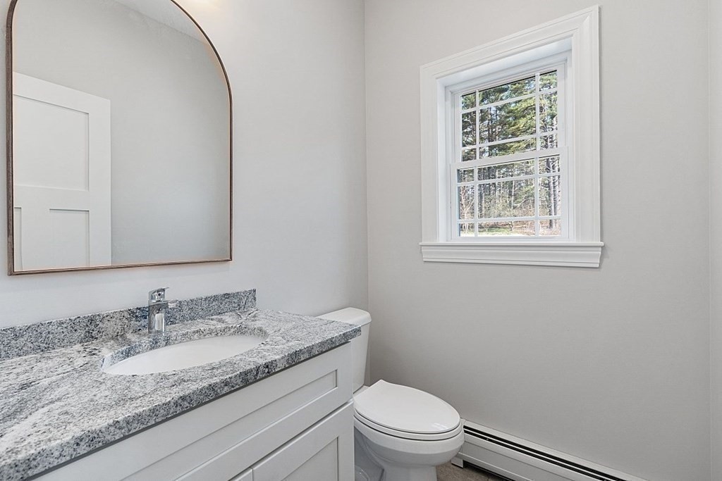 245 Brookside Road Orange, MA 01364 - Photo 18 of 29 a bathroom with a granite countertop sink toilet and mirror