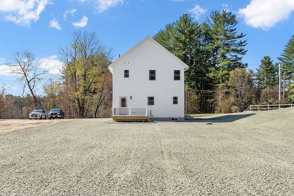 245 Brookside Road Orange, MA 01364 - Photo 25 of 29 a view of a white house with a yard and garage