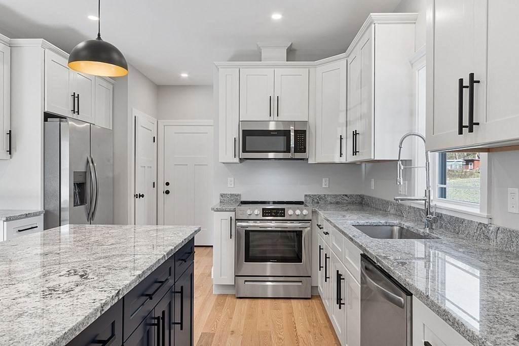 245 Brookside Road Orange, MA 01364 - Photo 6 of 29 a kitchen with stainless steel appliances granite countertop a sink stove and refrigerator