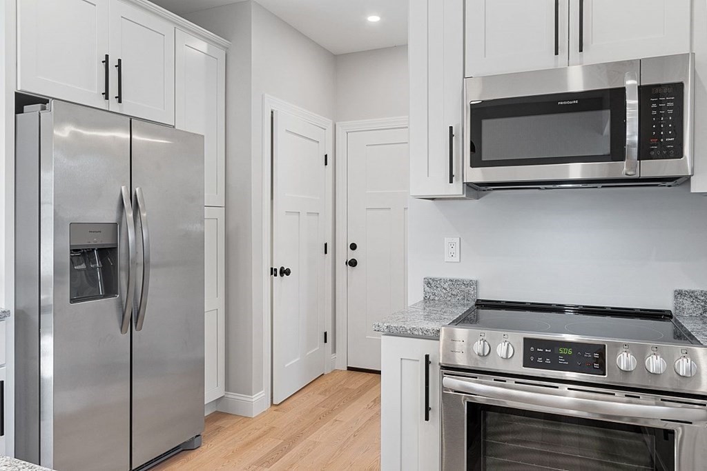 245 Brookside Road Orange, MA 01364 - Photo 8 of 29 a kitchen with stainless steel appliances wooden cabinets and a stove top oven