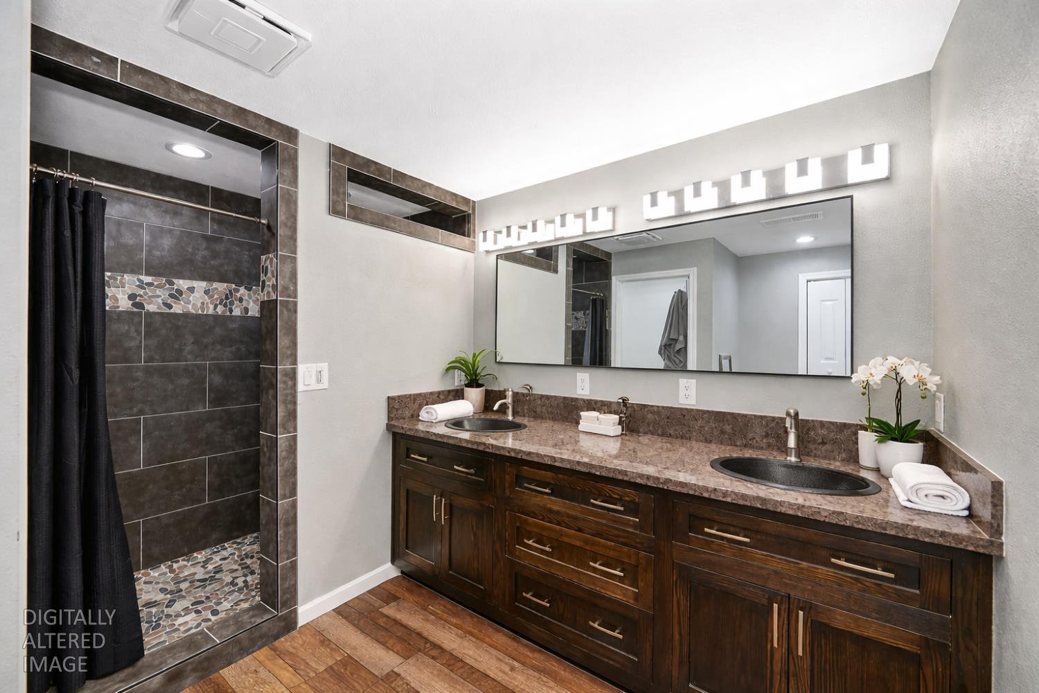 5682 Virginiatown Road Newcastle, CA 95658 - Photo 13 of 56 Primary bathroom featuring double vanity, custom tile shower, updated flooring, and exhaust fan with Bluetooth for listening to music while in the shower!