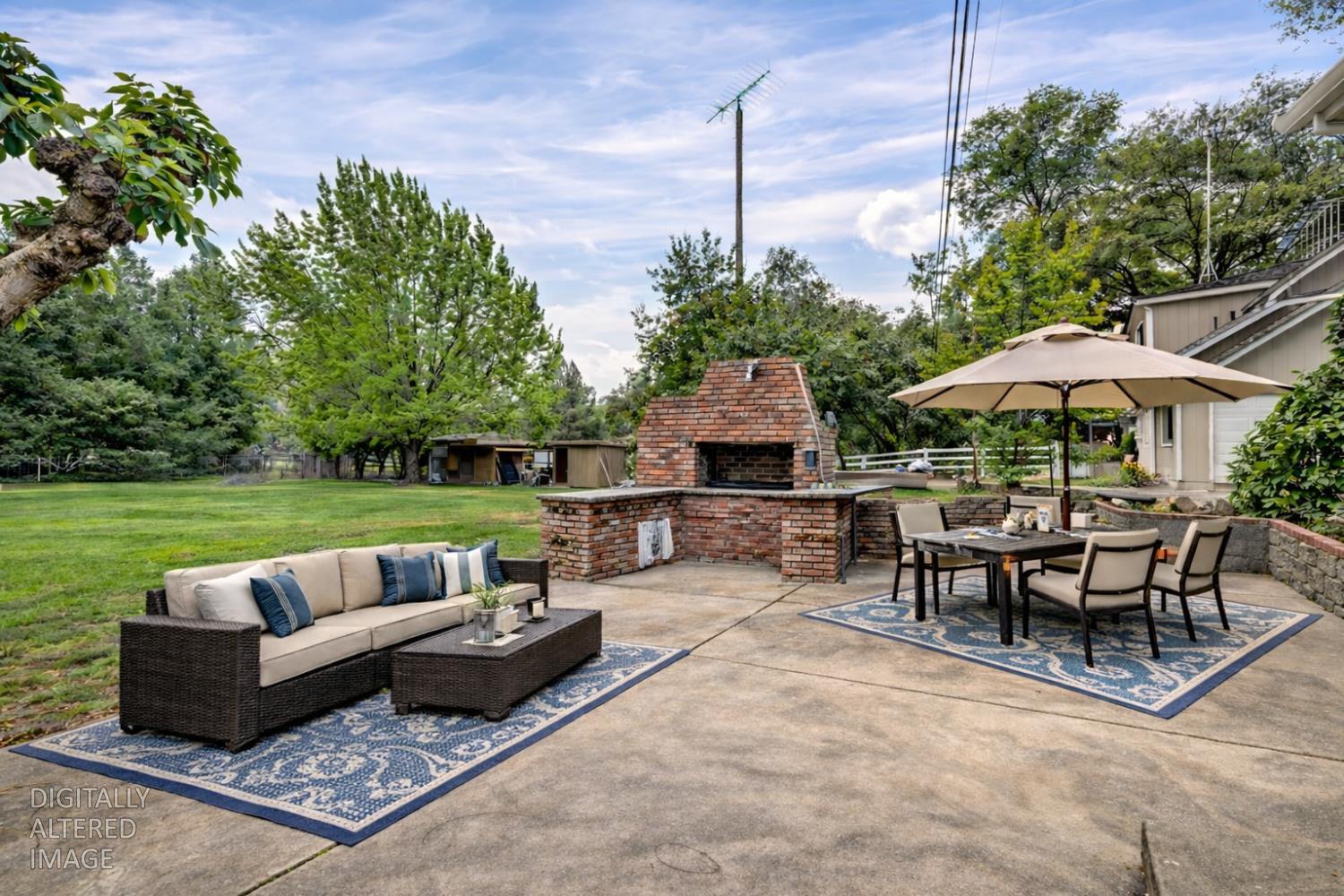 5682 Virginiatown Road Newcastle, CA 95658 - Photo 19 of 56 Enjoy outdoor living on the concrete patio with brick BBQ, ideal for entertaining or relaxing in the serene natural setting.