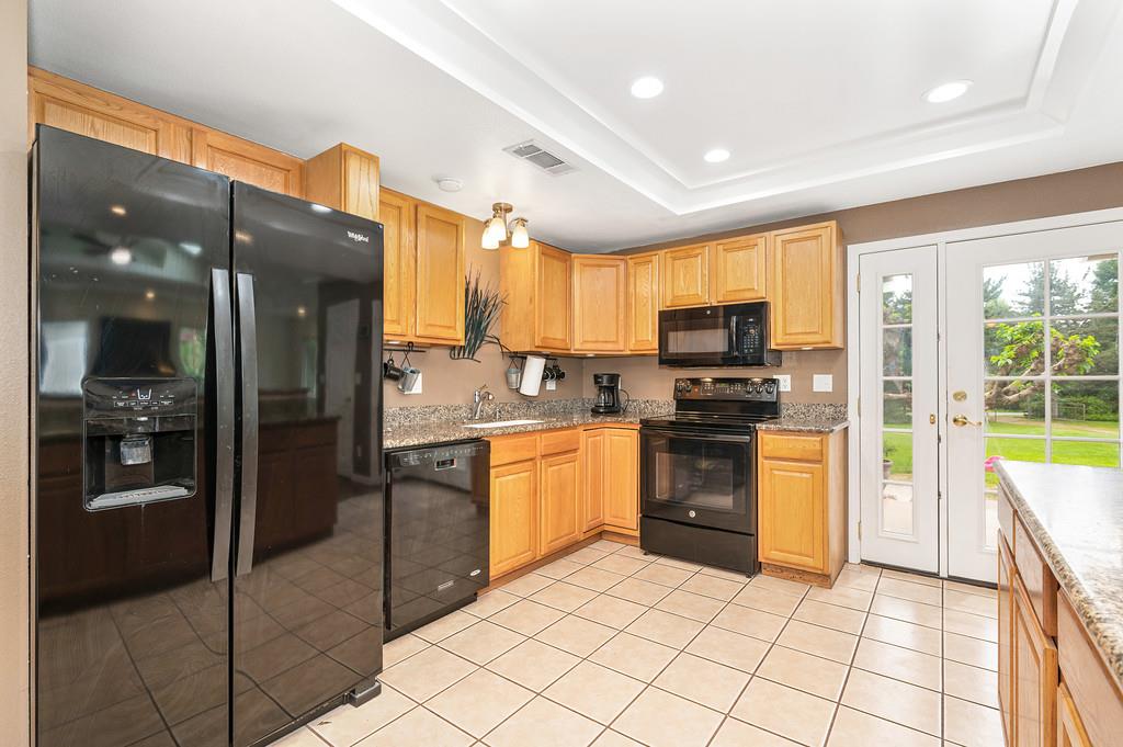 5682 Virginiatown Road Newcastle, CA 95658 - Photo 8 of 56 Updated kitchen features granite countertops and an eating bar for four door leads to backyard and patio.
