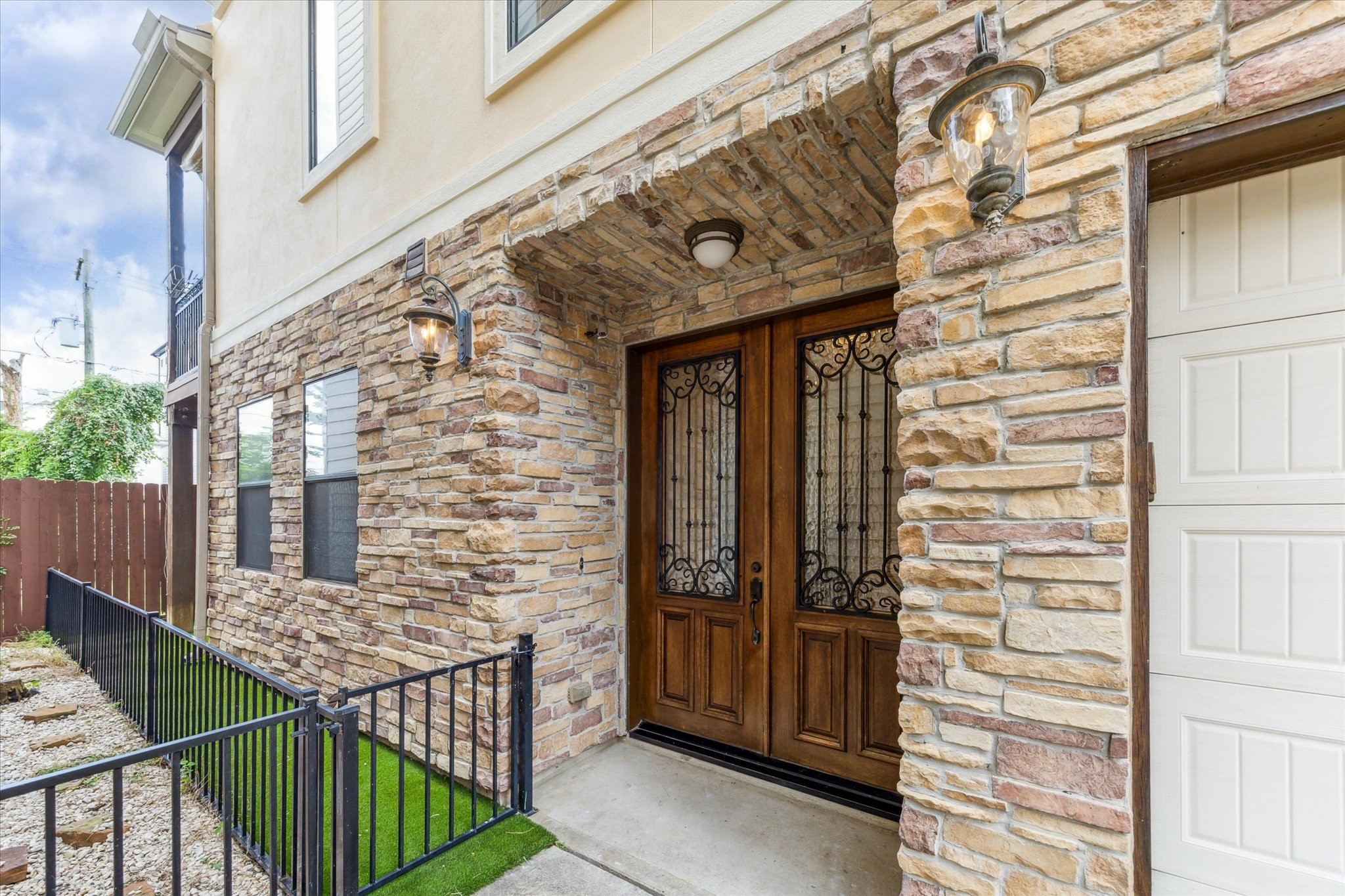 a view of a wooden door and brick wall