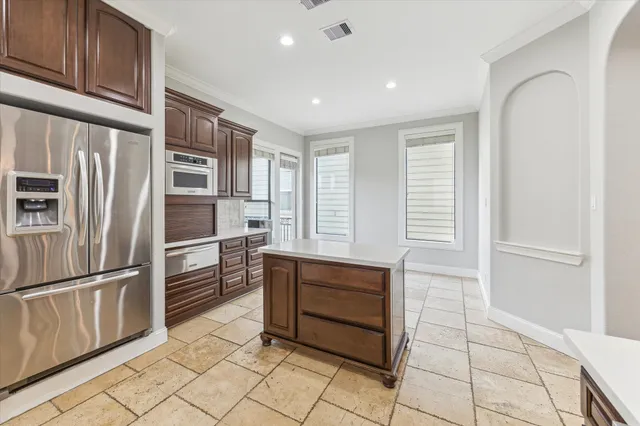 a kitchen with stainless steel appliances a refrigerator and a sink