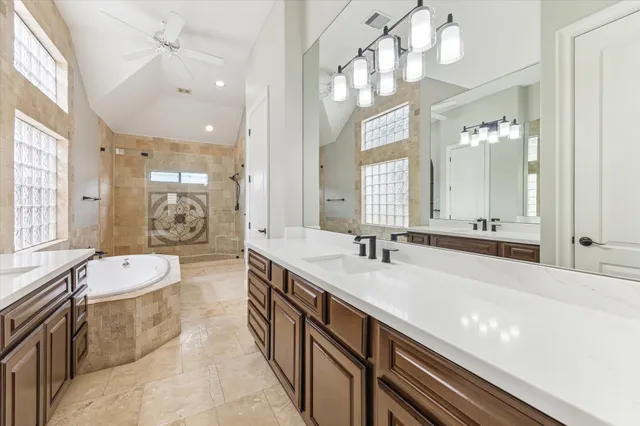 a spacious bathroom with a bathtub shower sink and mirror