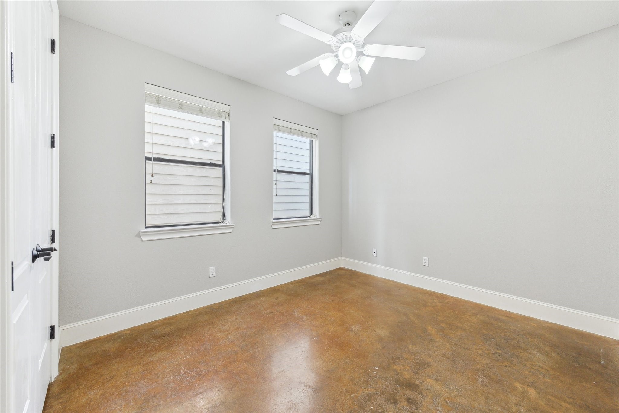 1512 Thompson Street, Unit 3 Houston, TX 77007 - Photo 24 of 32 The secondary bedroom on the first floor with neutral walls and a polished concrete floor and large closet.